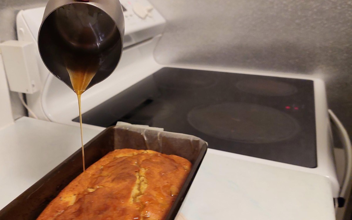 Pouring Honey Over The Hot Feijoa Loaf